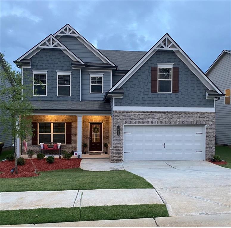 7760 Silk Tree Pointe Braselton, GA 30517 - Photo 1 of 1 a front view of a house with a garden and plants