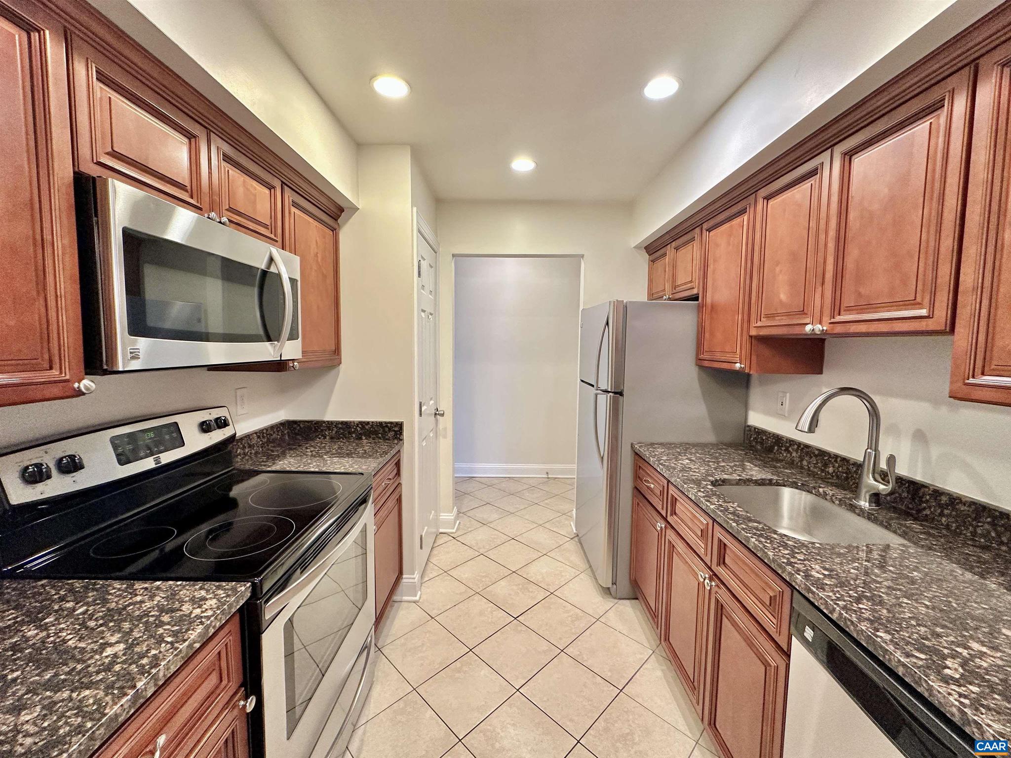 139 Green Turtle Lane, Unit 10 Charlottesville, VA 22901 - Photo 5 of 26 a kitchen with stainless steel appliances granite countertop a sink stove and refrigerator
