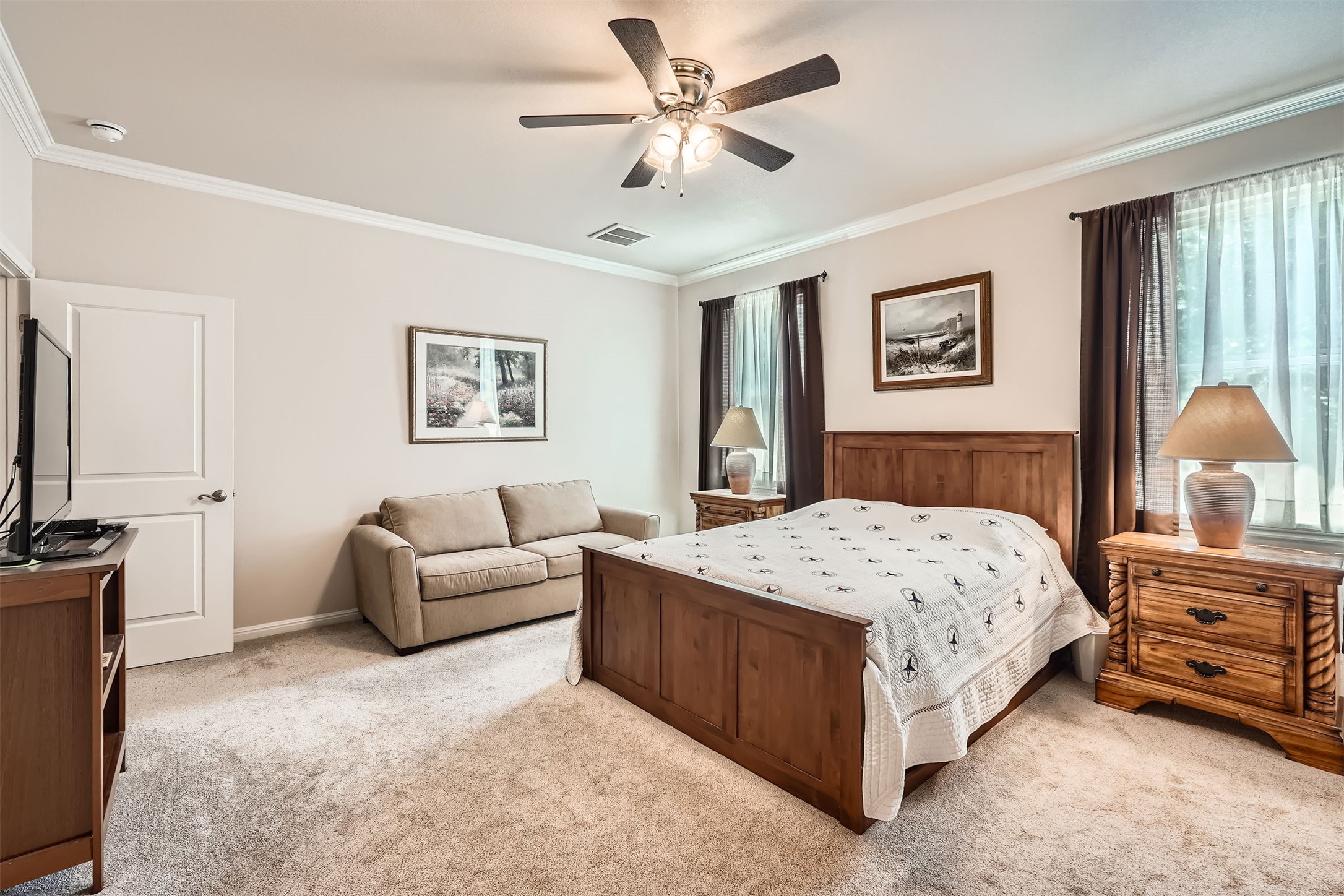 5501 Hitching Post Lago Vista, TX 78645 - Photo 15 of 26 a bedroom with a bed couches and a flat tv screen