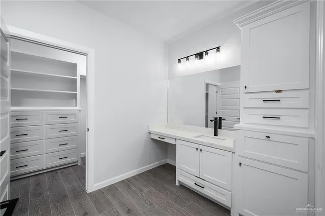 a bathroom with a double vanity sink a mirror and a vanity