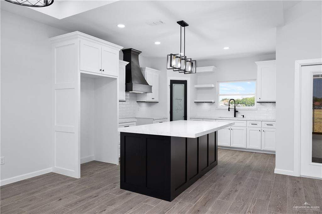2443 Lady Palm Drive Rio Grande City, TX 78582 - Photo 8 of 19 a kitchen with stainless steel appliances a sink a stove a refrigerator and island with wooden floor