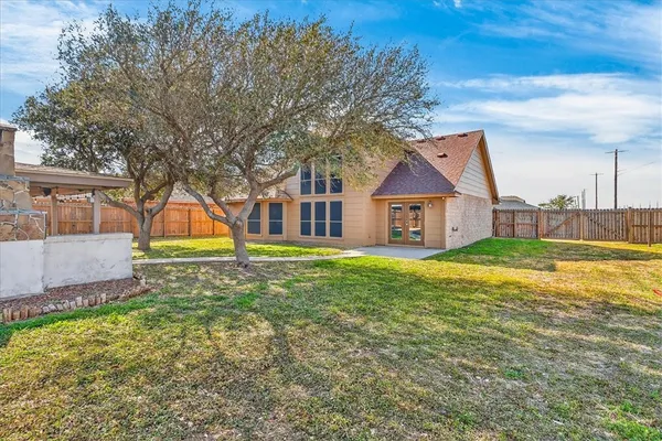 a view of a house with a yard and sitting area