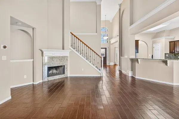 a view of a hallway with wooden floor and a fireplace