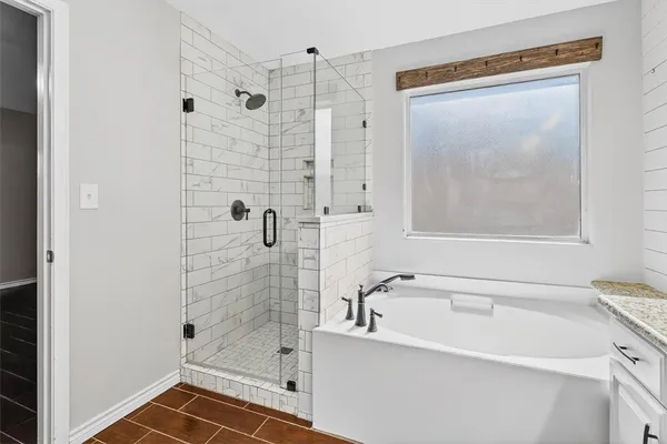 a bathroom with a bathtub and a shower