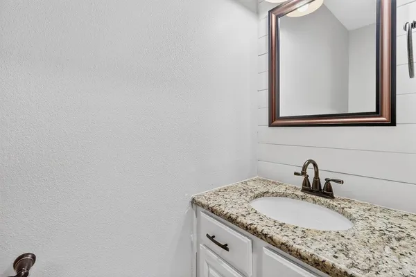 a bathroom with a sink and mirror