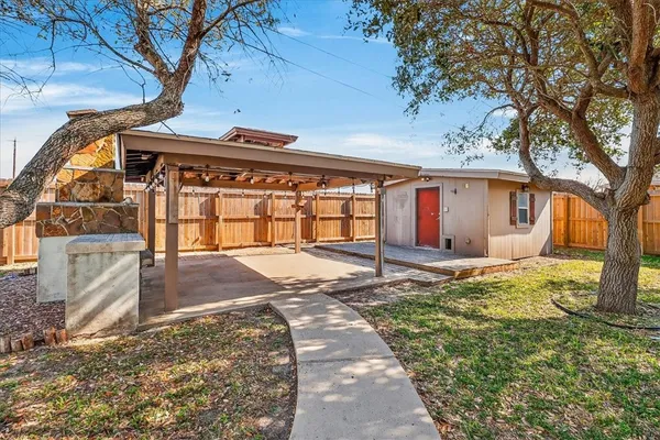 a view of a house with backyard and tree s