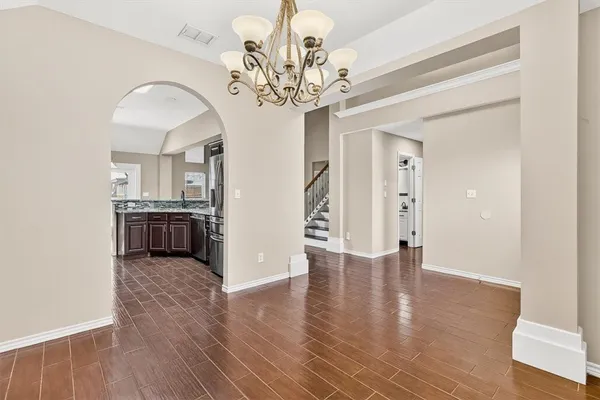 a view of a kitchen with a sink and dishwasher with wooden floor