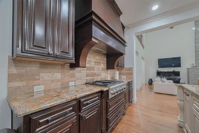 a kitchen with stainless steel appliances granite countertop a sink stove and cabinets