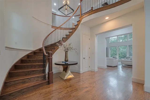 a view of entryway and hall with wooden floor