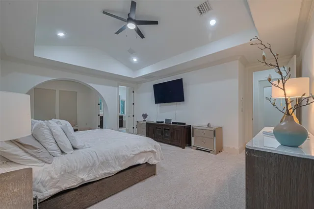 a living room with furniture a flat screen tv and kitchen view