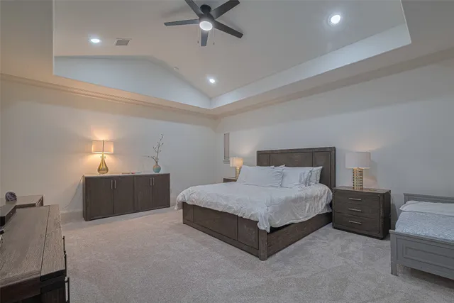 a spacious bedroom with a bed and a chandelier
