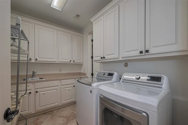 a view of cabinets a sink and dishwasher in a kitchen
