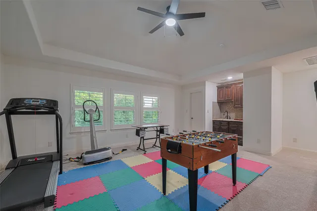 a living room with furniture and a air conditioner vent