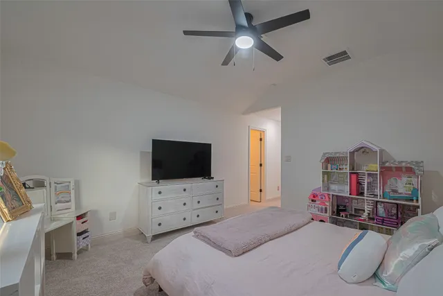 a bedroom with furniture and a flat screen tv