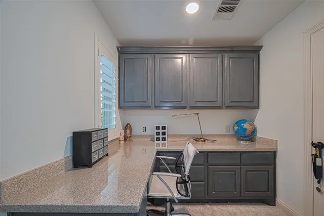 a kitchen with a refrigerator and cabinets