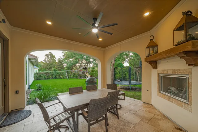 a view of a porch with furniture and a yard