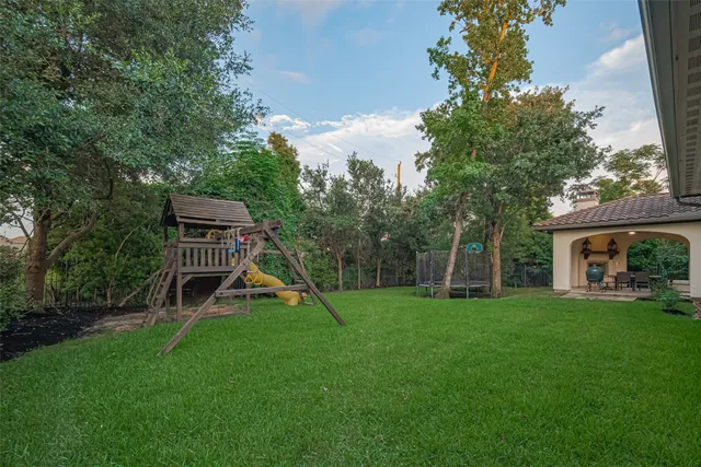 a view of a house with a backyard and a slide