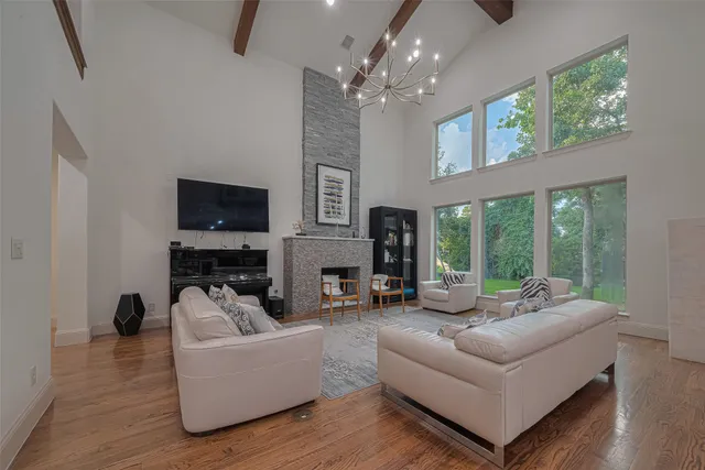 a living room with fireplace furniture and a flat screen tv