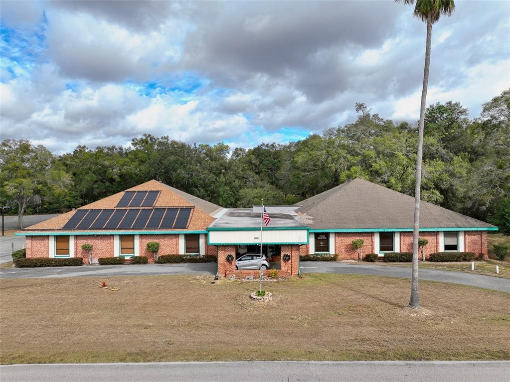 8274 Southwest 106th Place Ocala, FL 34481 - Photo 27 of 40 a front view of a house with yard and balcony