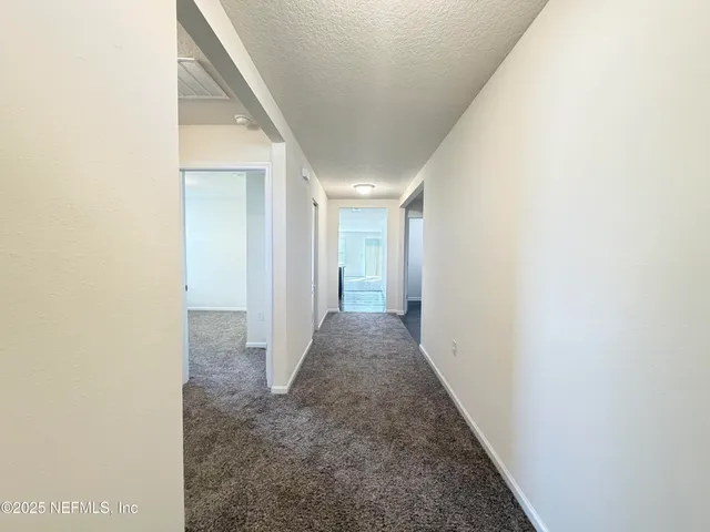 an empty room with a empty space and windows