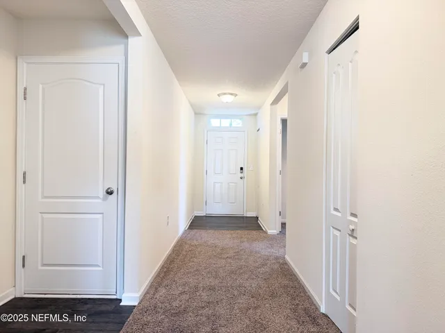 a kitchen with stainless steel appliances granite countertop a refrigerator a sink dishwasher a stove with wooden floor and cabinets