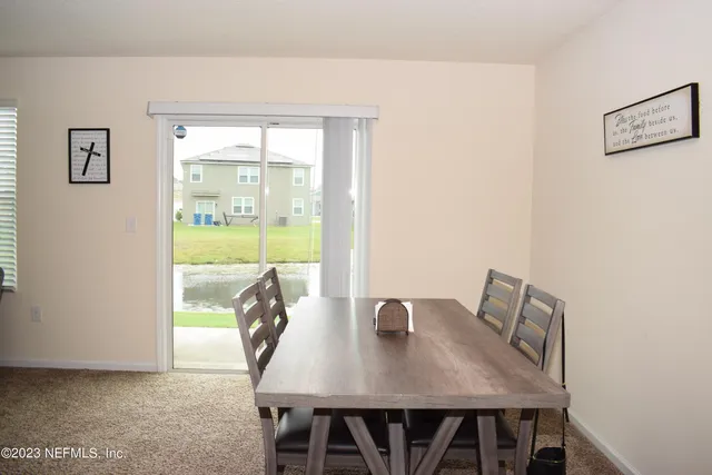 a view of a dining room with furniture and window
