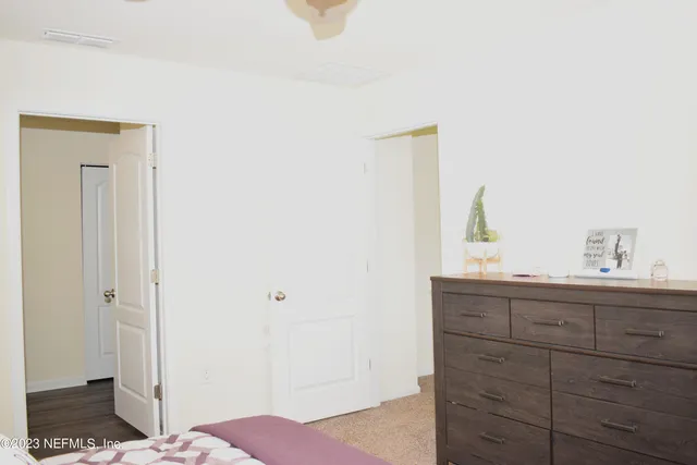 a view of bedroom with wooden floor