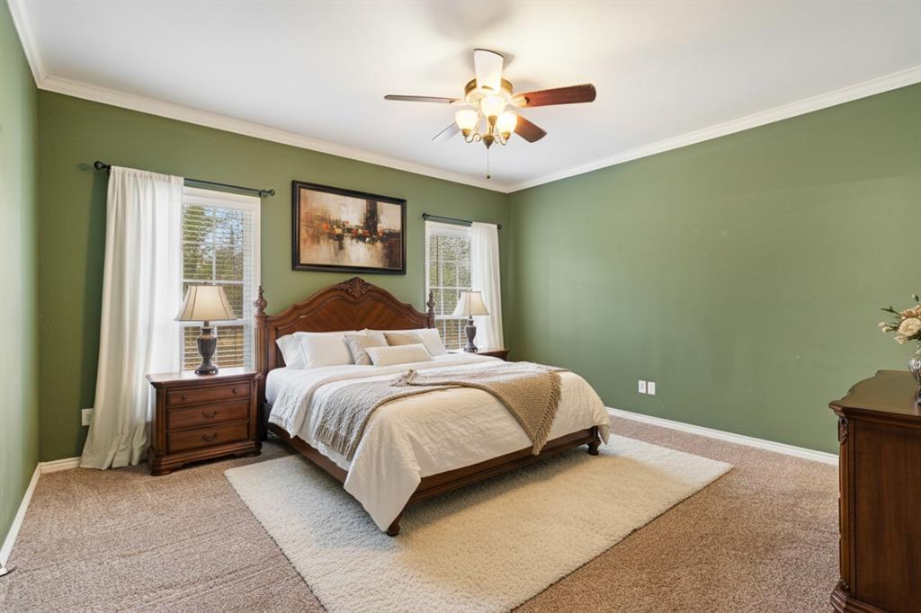126 Hidden Lake Drive Powderly, TX 75473 - Photo 11 of 29 a bedroom with a large bed and a chandelier