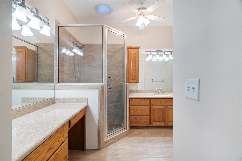 126 Hidden Lake Drive Powderly, TX 75473 - Photo 12 of 29 a bathroom with a sink a vanity and a mirror