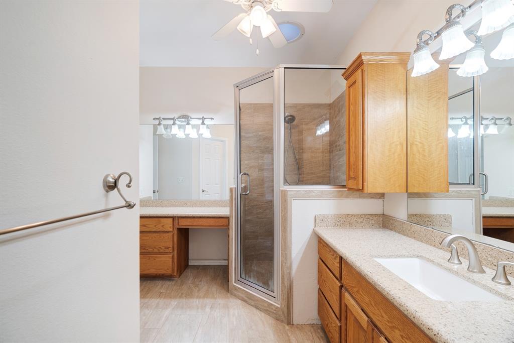 126 Hidden Lake Drive Powderly, TX 75473 - Photo 13 of 29 a bathroom with a sink double vanity and a shower