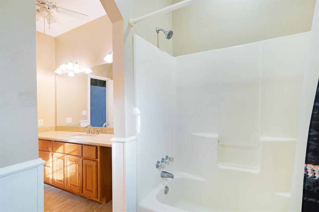 126 Hidden Lake Drive Powderly, TX 75473 - Photo 16 of 29 a bathroom with a tub sink and mirror