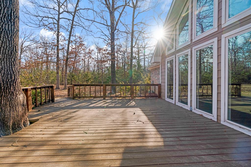 126 Hidden Lake Drive Powderly, TX 75473 - Photo 26 of 29 a view of a balcony with wooden floor and fence