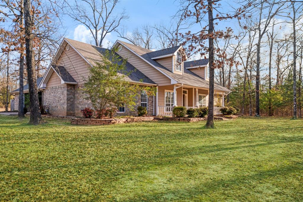 126 Hidden Lake Drive Powderly, TX 75473 - Photo 29 of 29 a view of a big house with a big yard and large trees