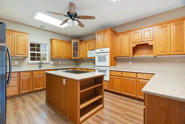 a kitchen with stainless steel appliances granite countertop a stove and a sink