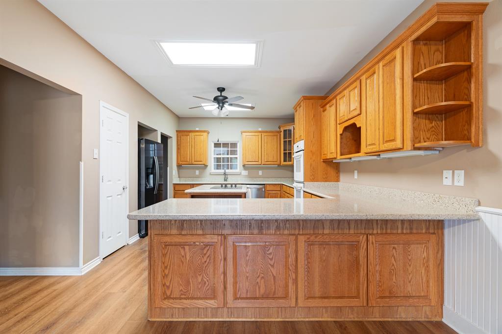 126 Hidden Lake Drive Powderly, TX 75473 - Photo 9 of 29 a bathroom with a sink a mirror and a shower