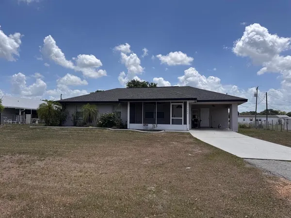 a front view of a house with a yard and a garage
