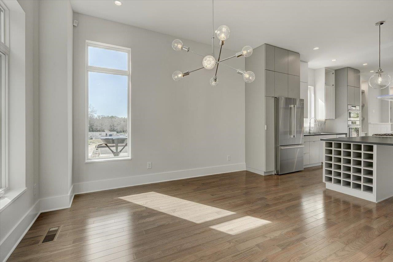 749 Willard Street, Unit 7 Durham, NC 27701 - Photo 12 of 43 a view of an empty room with wooden floor and a window