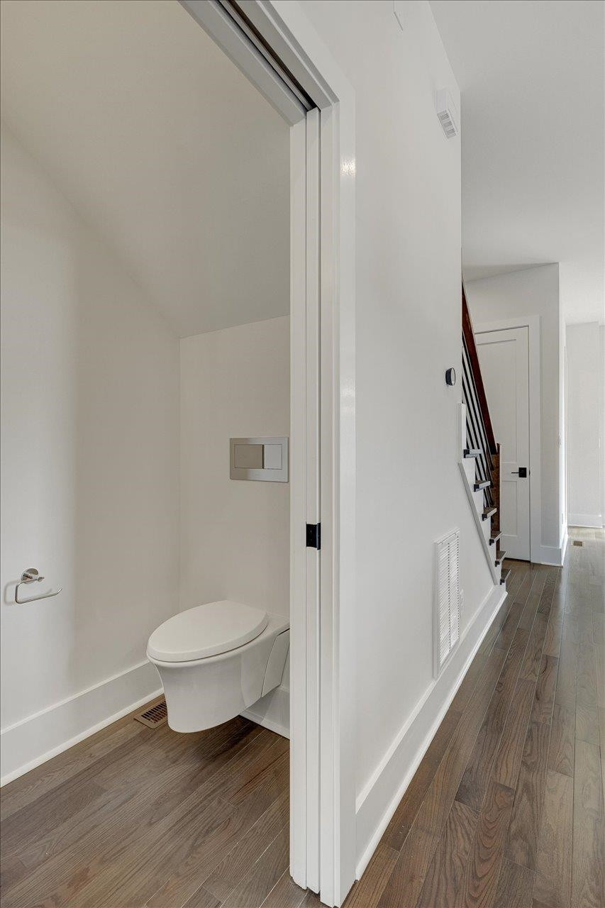 749 Willard Street, Unit 7 Durham, NC 27701 - Photo 14 of 43 a bathroom with a toilet and a wooden floor