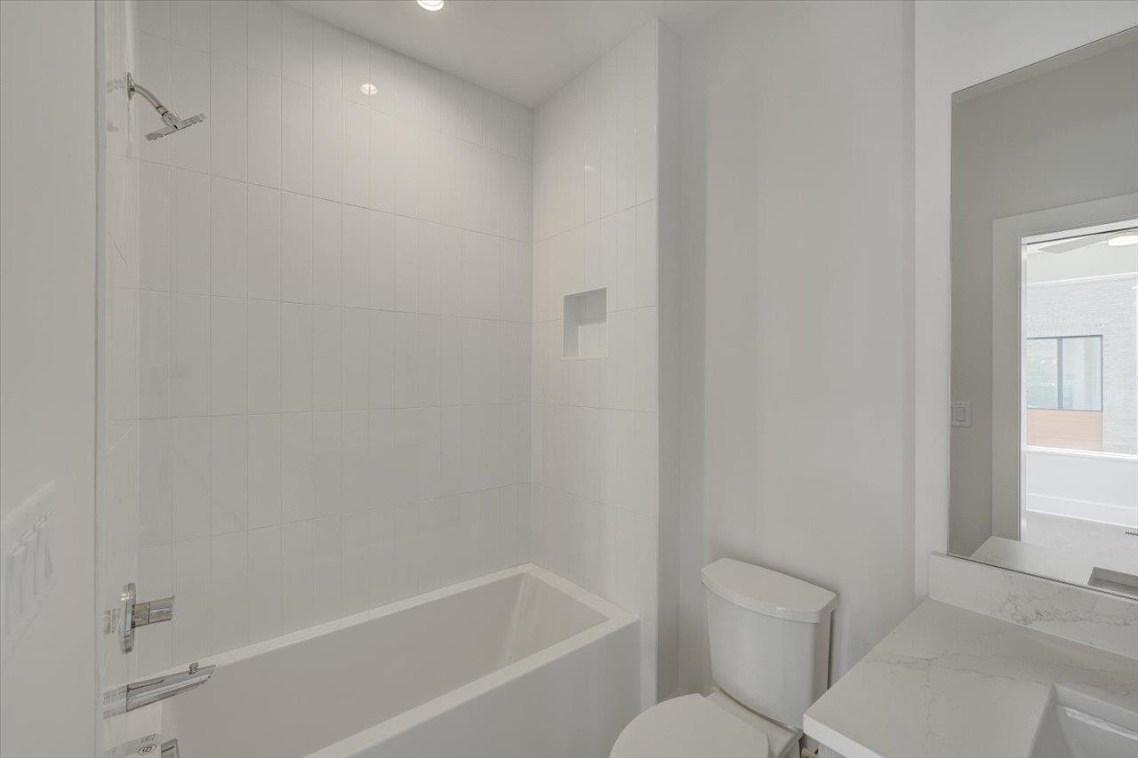 749 Willard Street, Unit 7 Durham, NC 27701 - Photo 17 of 43 a white bath tub sitting next to a toilet