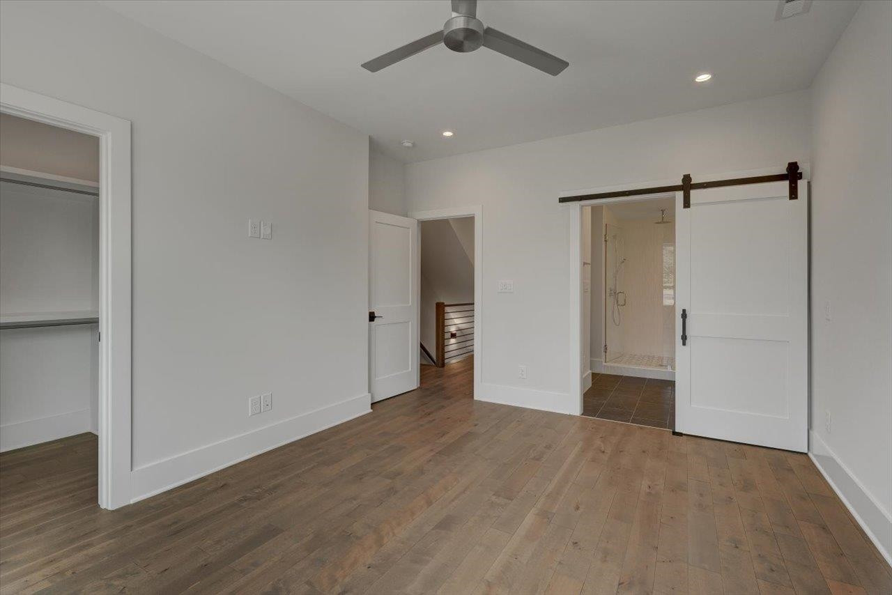 749 Willard Street, Unit 7 Durham, NC 27701 - Photo 18 of 43 a view of an empty room with wooden floor and a ceiling fan