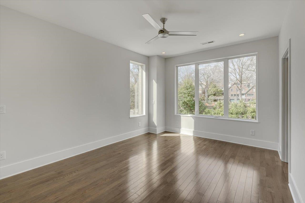 749 Willard Street, Unit 7 Durham, NC 27701 - Photo 19 of 43 a view of an empty room with wooden floor and a window