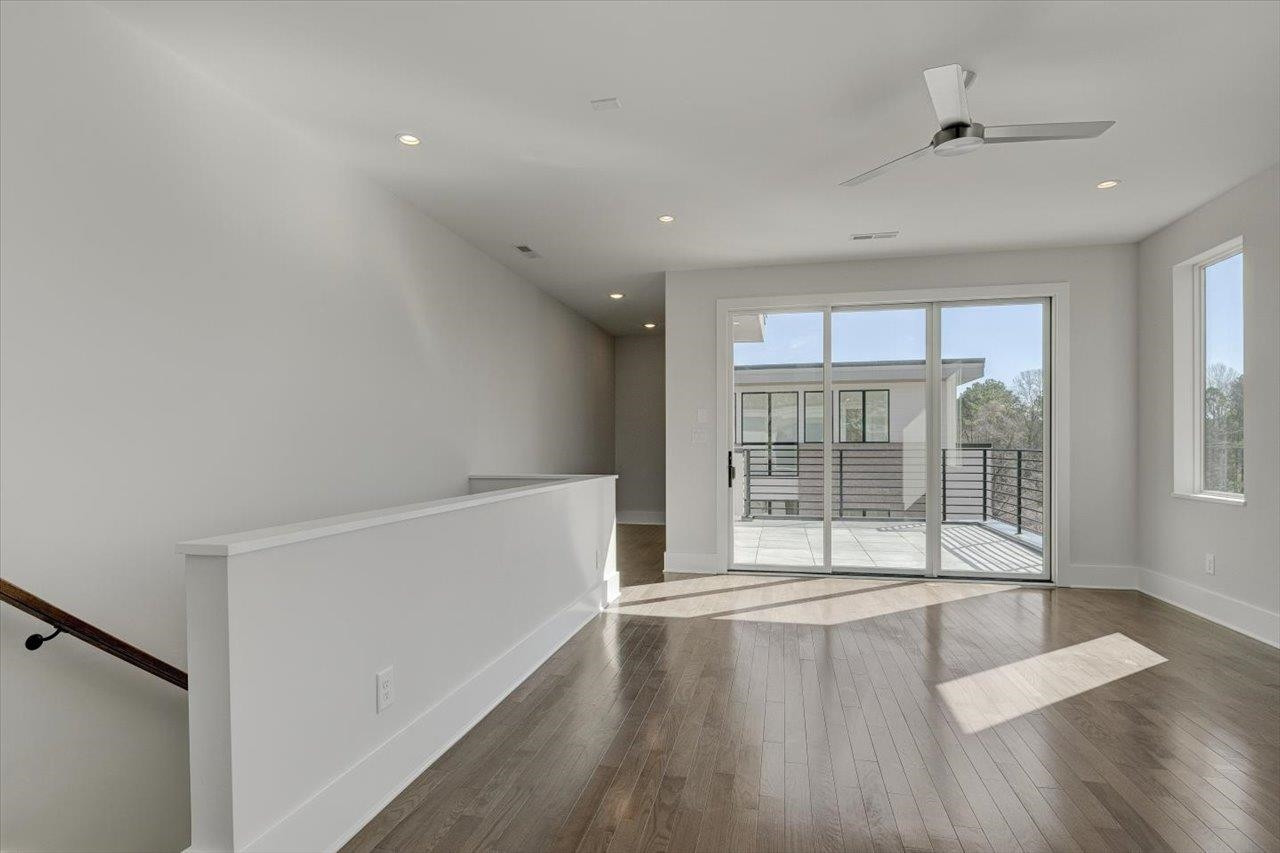 749 Willard Street, Unit 7 Durham, NC 27701 - Photo 22 of 43 a view of an empty room with wooden floor and a window