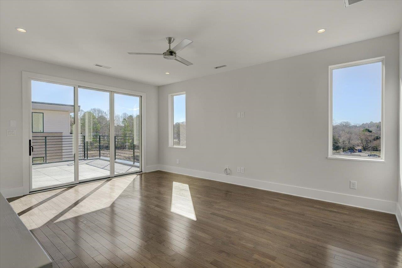 749 Willard Street, Unit 7 Durham, NC 27701 - Photo 24 of 43 a view of an empty room with wooden floor and a window
