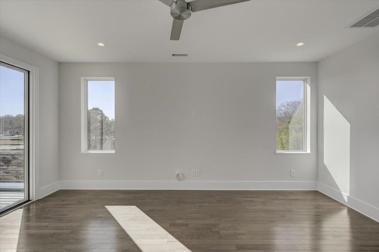 749 Willard Street, Unit 7 Durham, NC 27701 - Photo 25 of 43 an empty room with wooden floor and windows