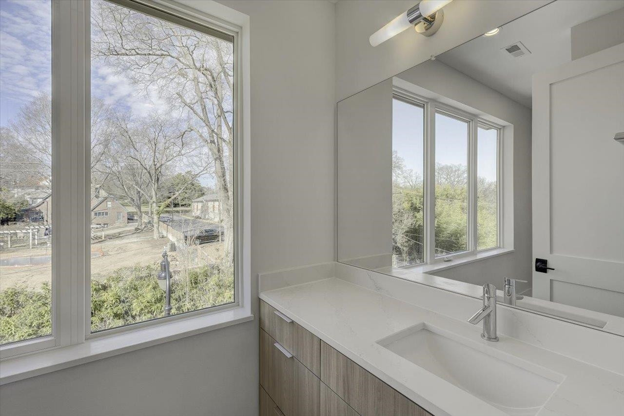 749 Willard Street, Unit 7 Durham, NC 27701 - Photo 26 of 43 a bathroom with a sink and a large mirror