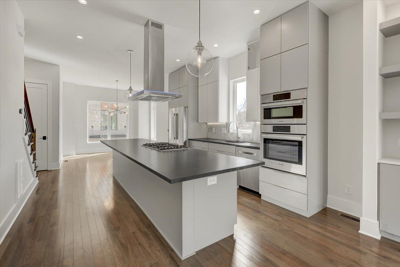749 Willard Street, Unit 7 Durham, NC 27701 - Photo 6 of 43 a kitchen with stainless steel appliances granite countertop a sink a stove and a refrigerator