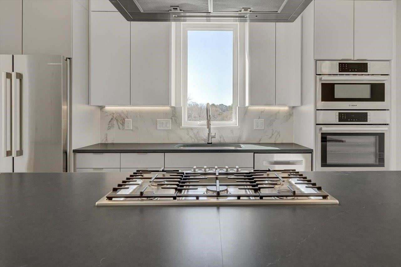 749 Willard Street, Unit 7 Durham, NC 27701 - Photo 9 of 43 a kitchen with granite countertop a stove and a microwave