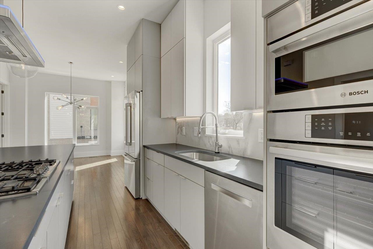 749 Willard Street, Unit 7 Durham, NC 27701 - Photo 10 of 43 a kitchen with stainless steel appliances granite countertop a stove and a sink
