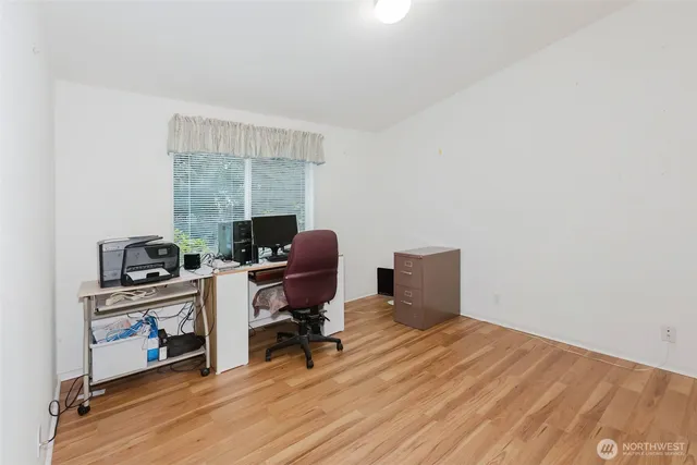 a view of a workspace with furniture and a window