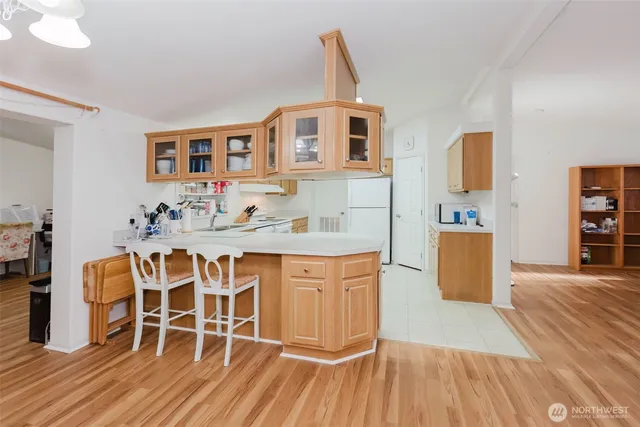 a dining room with wooden floor and furniture